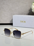 Dior sunglasses with gold-tone frame and dark navy lenses