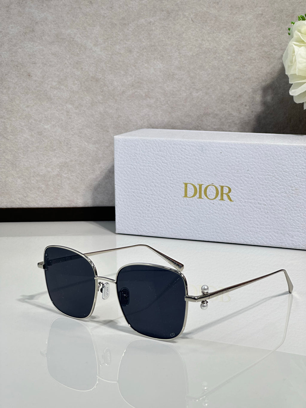 Dior sunglasses with silver-tone frame and dark blue lenses