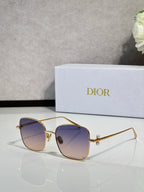 Dior sunglasses with gold-tone frame and blue-tinted lenses