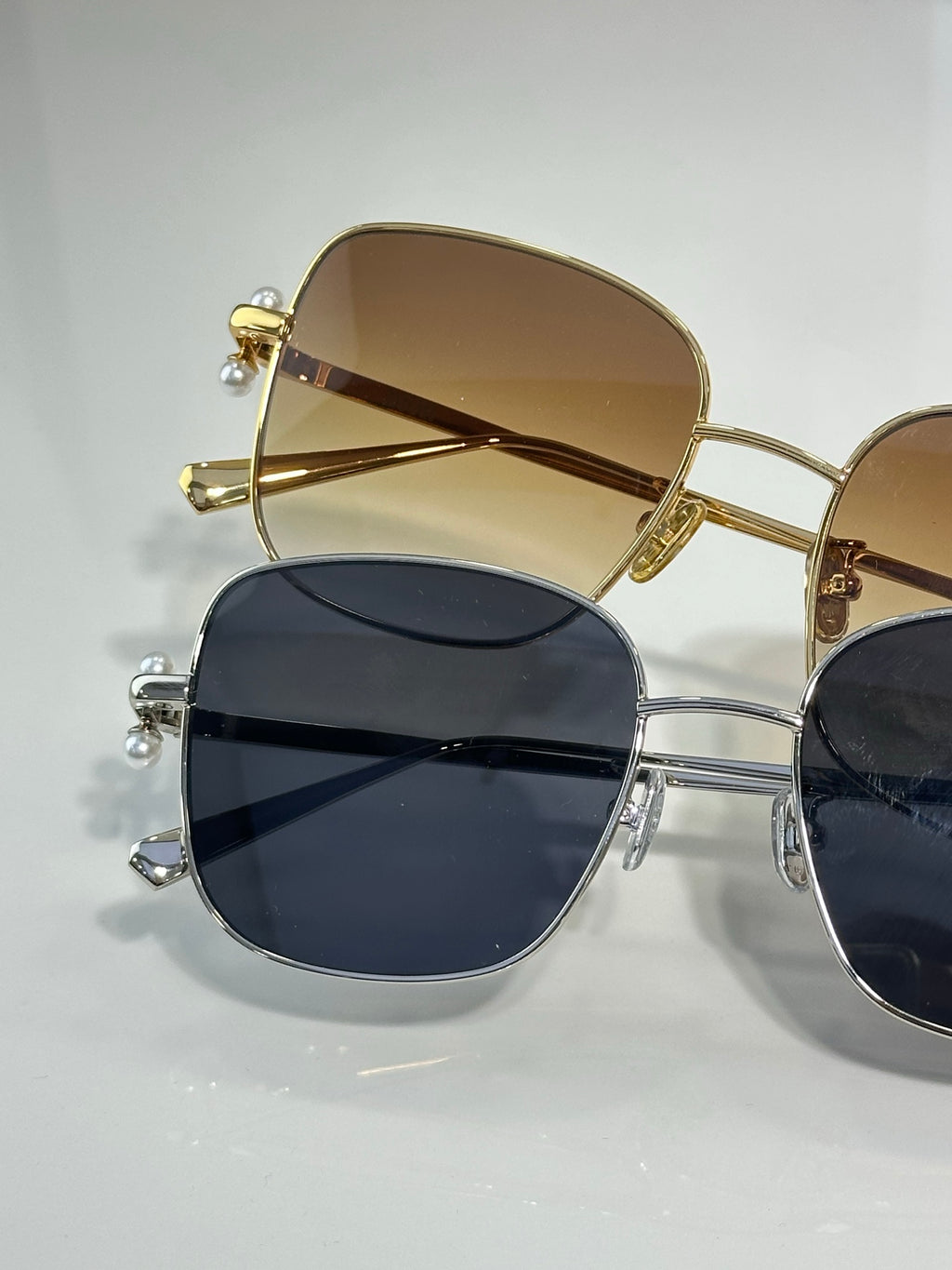 Dior sunglasses close-up with gold-tone frame and dark lenses
