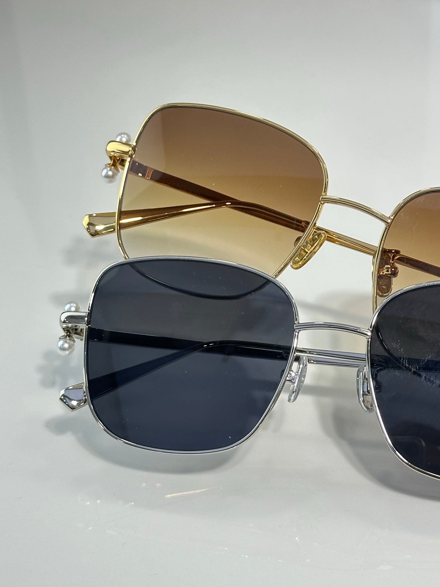 Dior sunglasses close-up with gold-tone frame and dark lenses