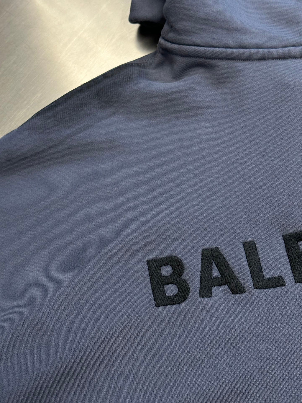 Light blue hoodie chest print with large black BALENCIAGA letters