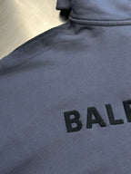 Light blue hoodie chest print with large black BALENCIAGA letters