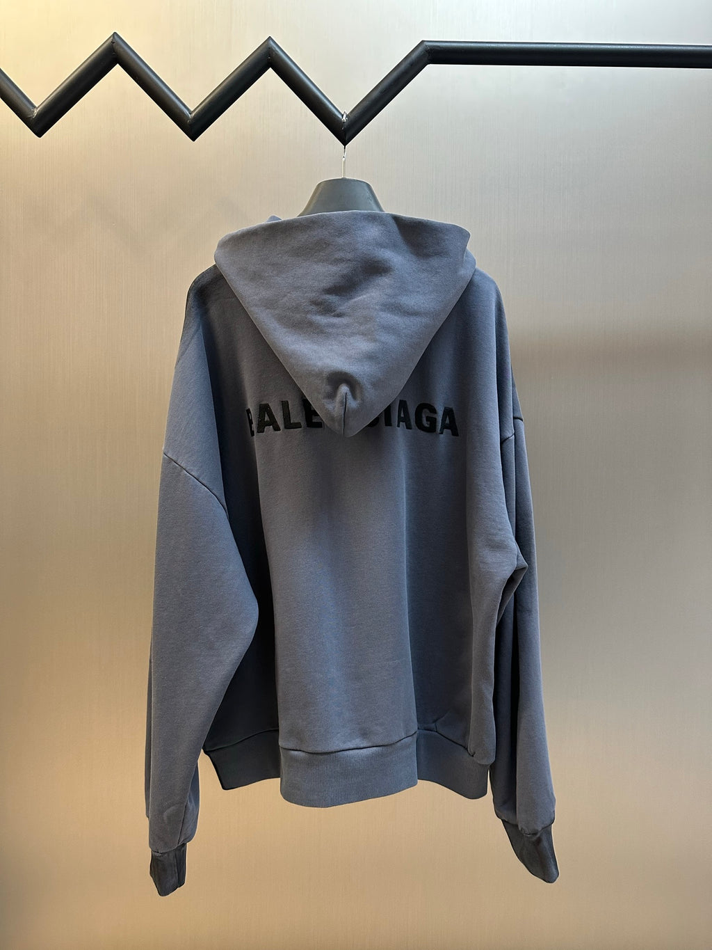 Light blue hoodie back view with hood, full-length zipper, large BALENCIAGA print