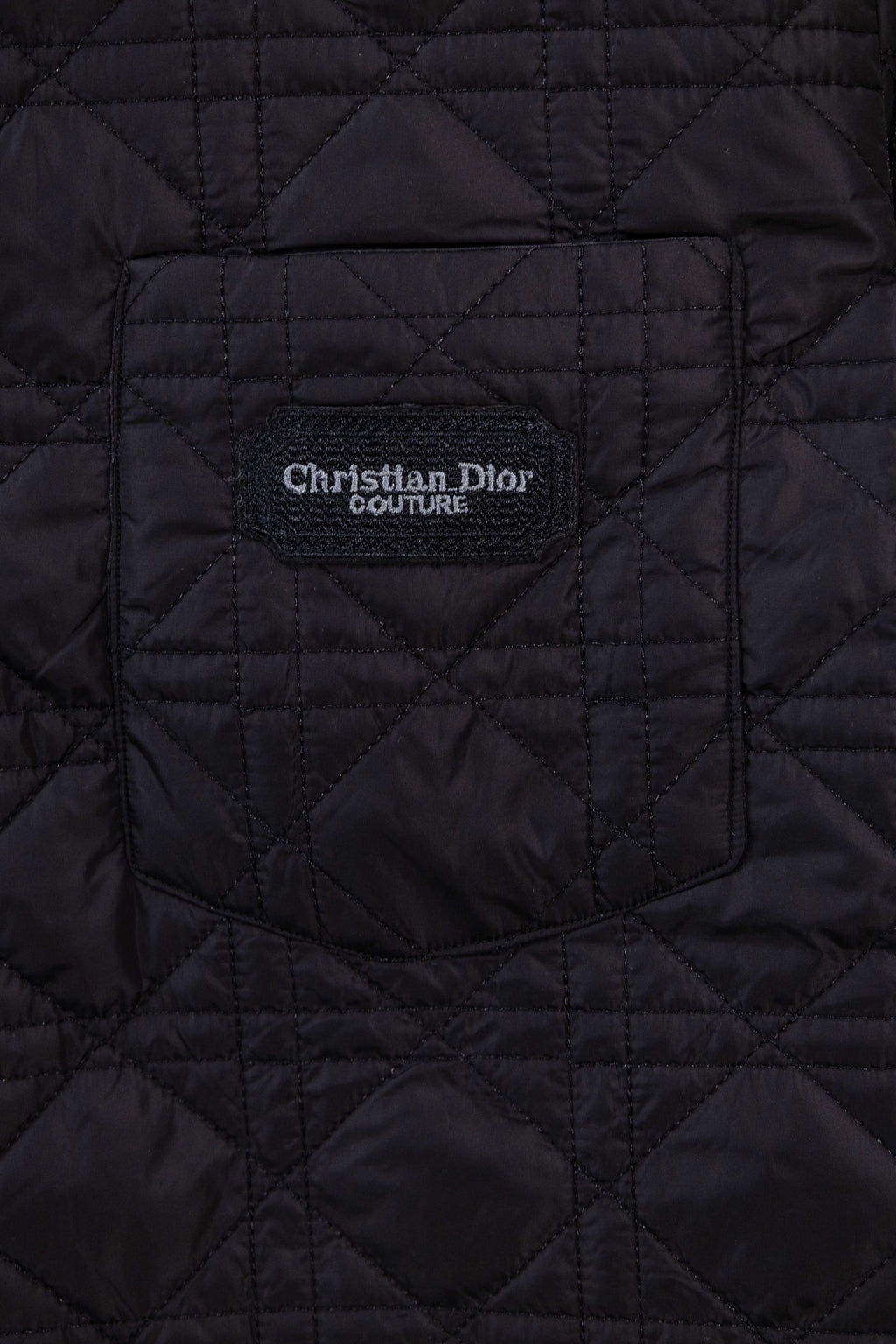 Black quilted jacket with Christian Dior Couture logo patch