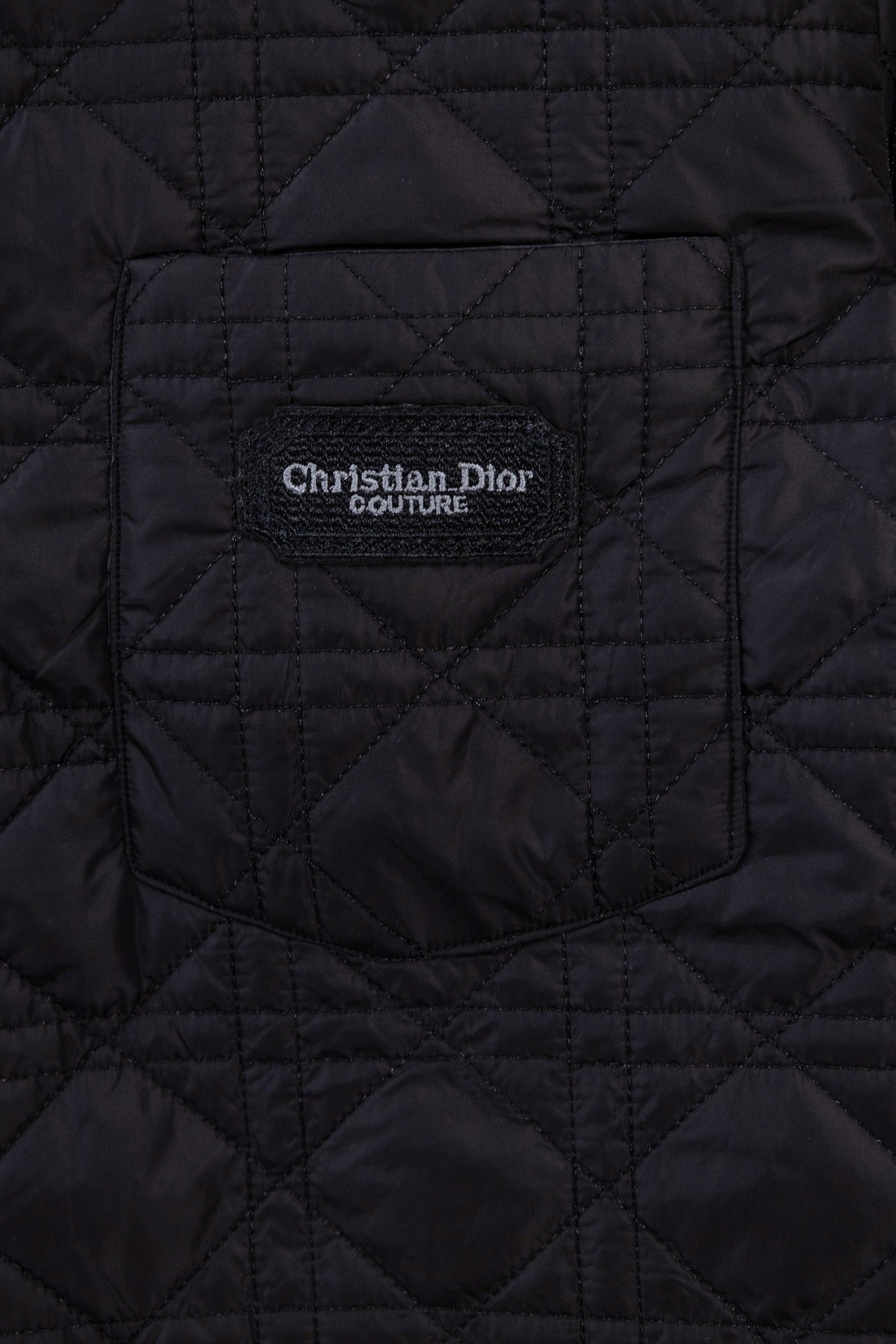 Black quilted jacket with Christian Dior Couture logo patch