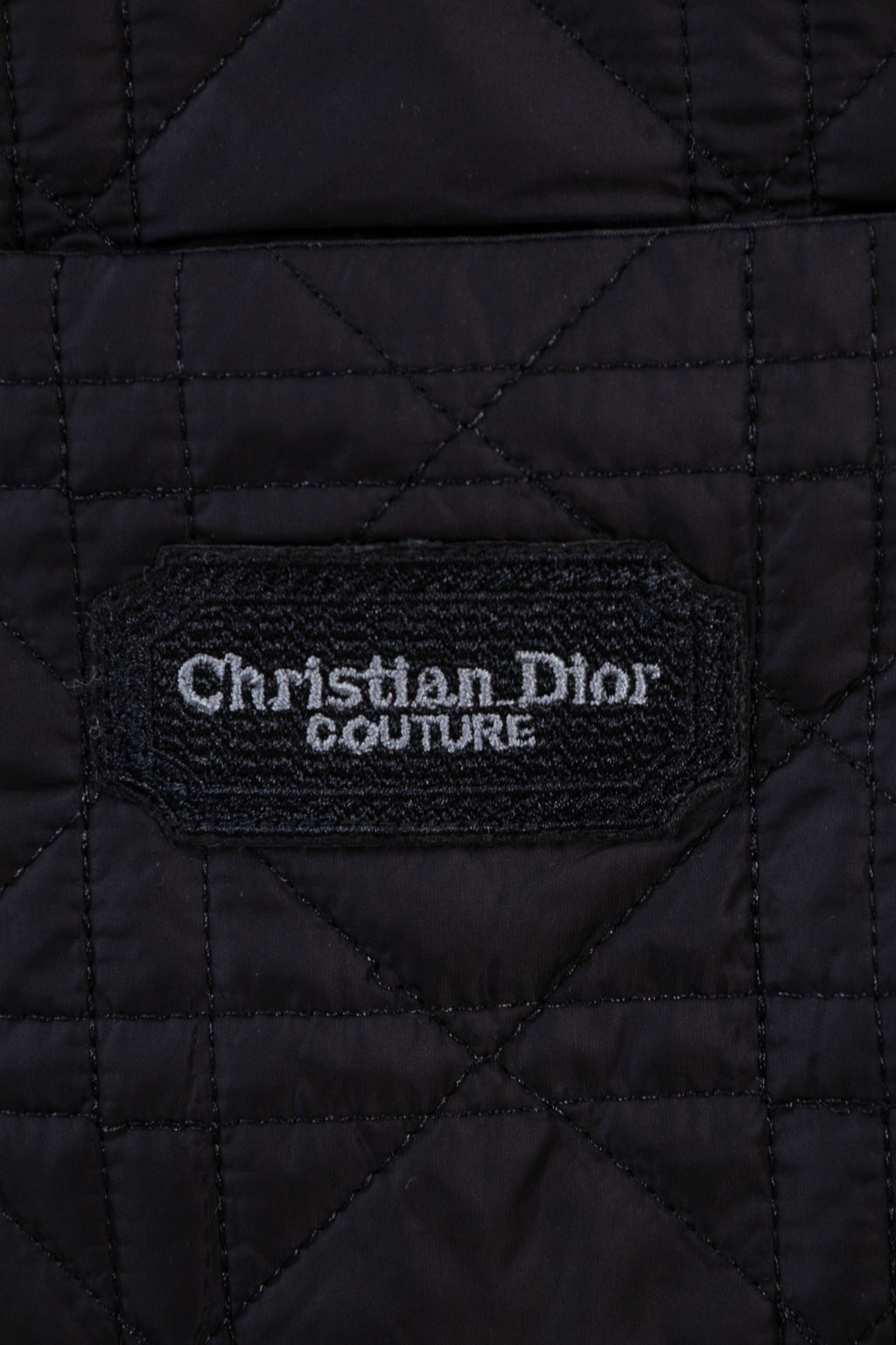 Black quilted jacket interior label reading Christian Dior Couture