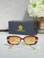 Versace red sunglasses with gold-tone arms and dark tinted lenses