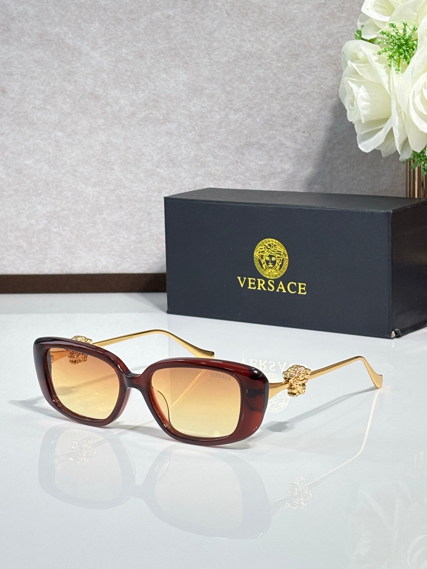 Versace brown sunglasses with gold-tone arms and amber tinted lenses