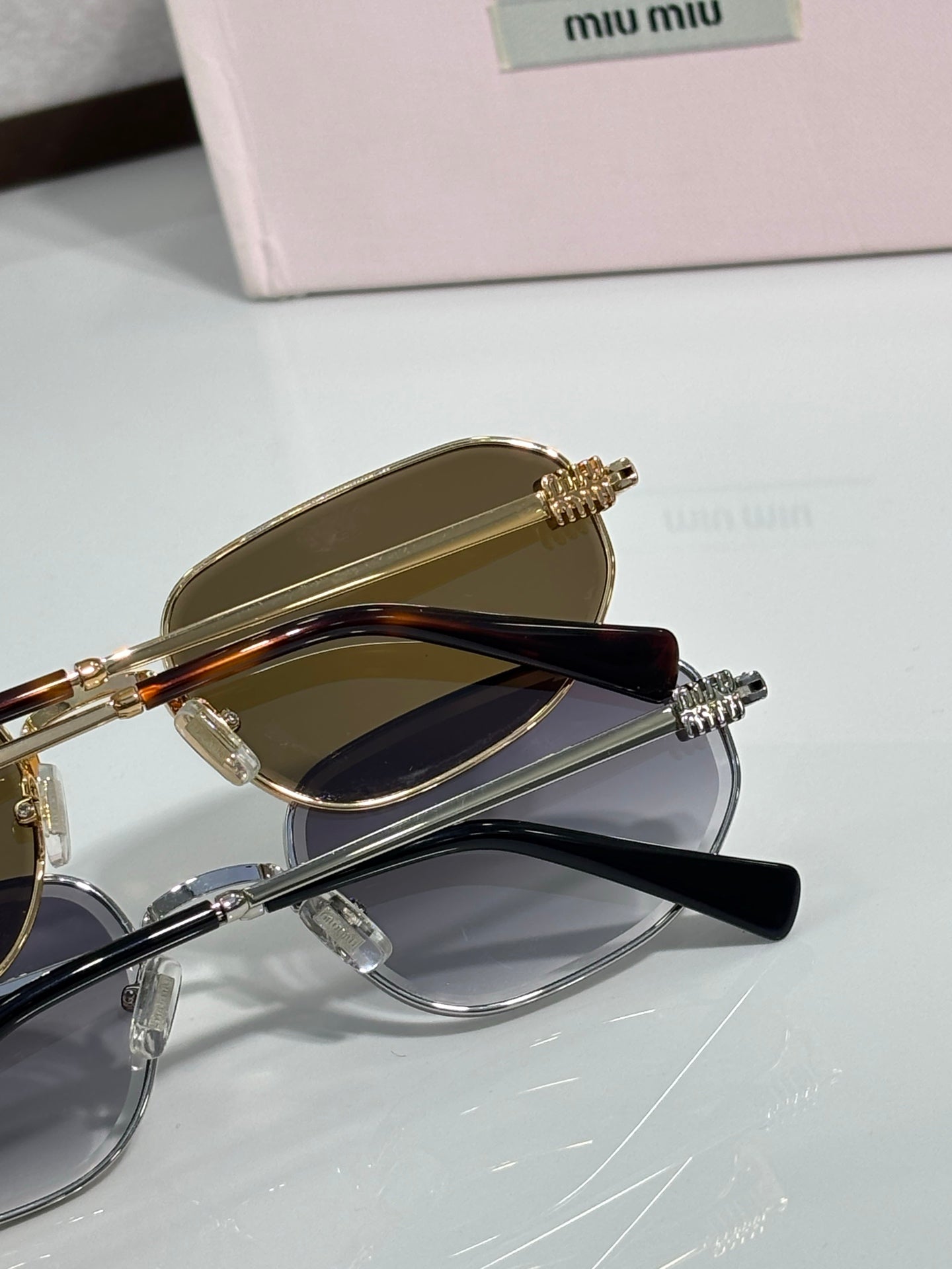 Stacked sunglasses set with gold and clear frames, tinted lenses, metal temple details