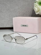 Silver metal sunglasses with clear lenses, round cat-eye shape, slim metal temples