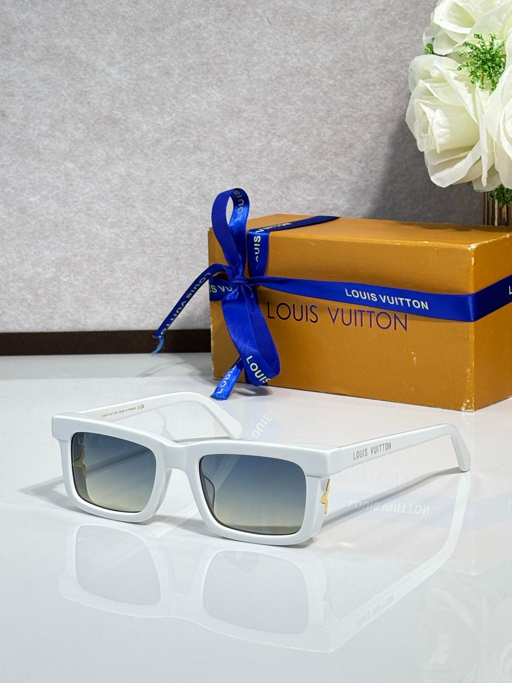 Louis Vuitton rectangular sunglasses with white frame and dark lenses