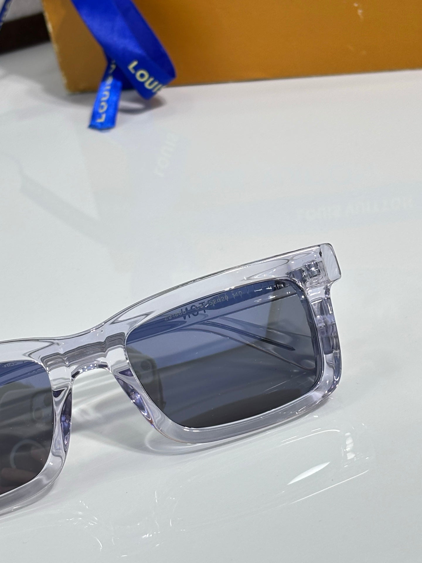 Clear eyeglasses with thick frame and blue-tinted lenses