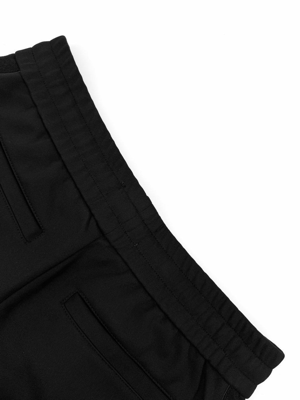 Black Dior pants seam and pleated waistband detail