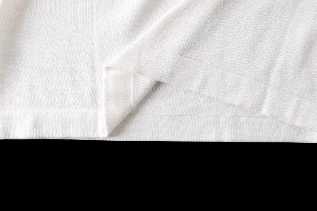 White T-shirt hem and side seam close-up