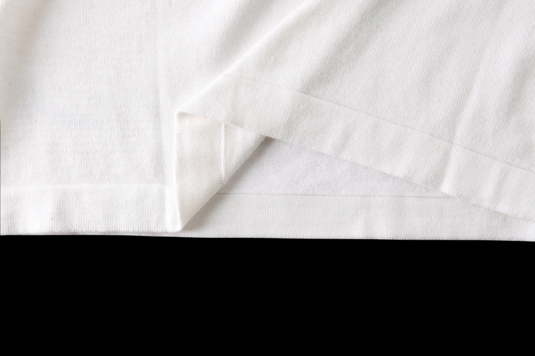 White T-shirt hem and side seam close-up
