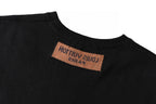 Black T-shirt neck label with brown tag text