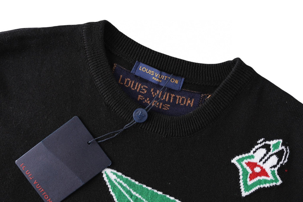 Black T-shirt neckline with blue button and Louis Vuitton neck tag