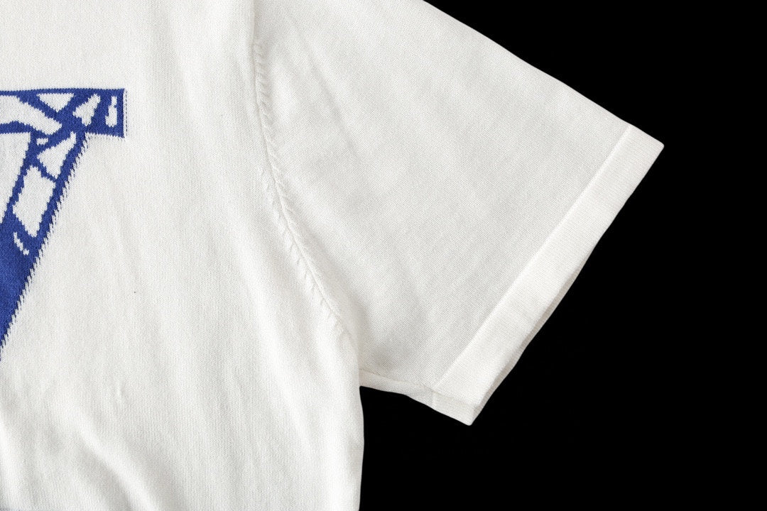 Louis Vuitton T-shirt side view, white short sleeve with blue graphic partially visible