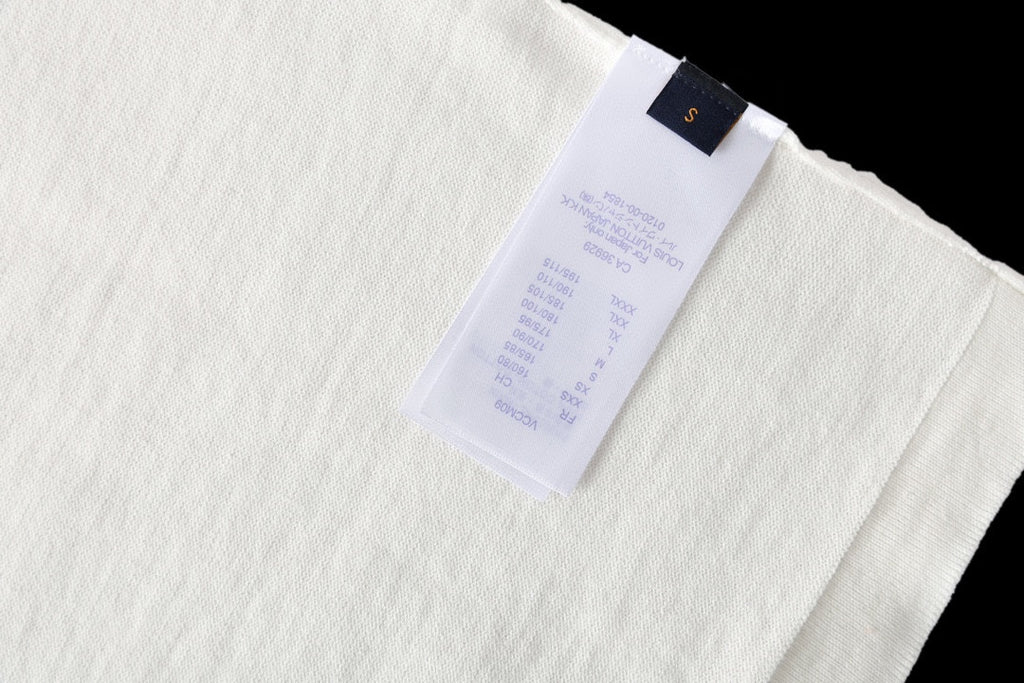 Louis Vuitton T-shirt inside label, white fabric with blue brand tag and care text