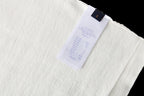 Louis Vuitton T-shirt inside label, white fabric with blue brand tag and care text