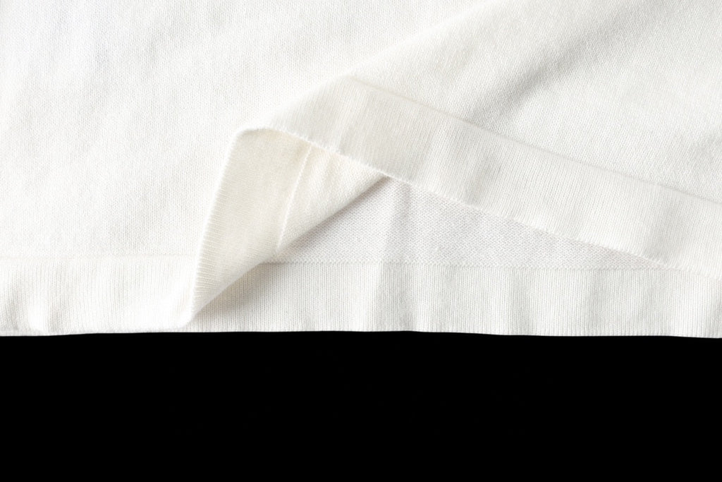 Louis Vuitton T-shirt hem close-up, white fabric with draped fold