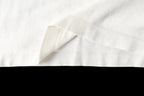 Louis Vuitton T-shirt hem close-up, white fabric with draped fold