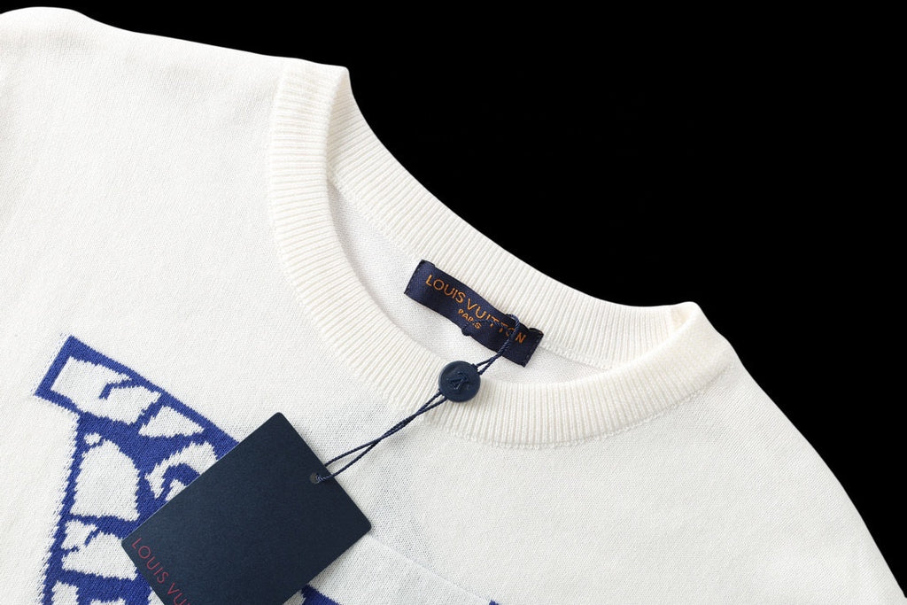 Louis Vuitton T-shirt collar close-up, white knit with blue logo patch at neckline