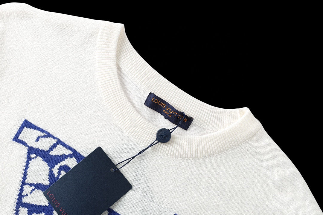 Louis Vuitton T-shirt collar close-up, white knit with blue logo patch at neckline