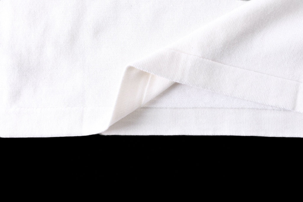 White T-shirt lower hem with clean stitched side seam