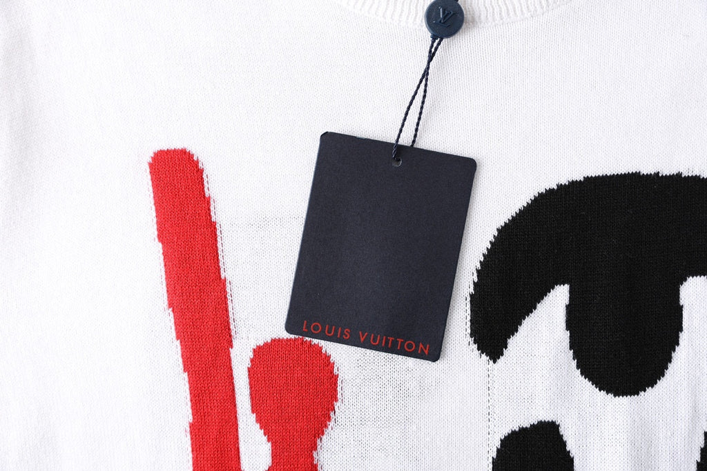 White T-shirt with red vertical line and black graphic, black hang tag near collar