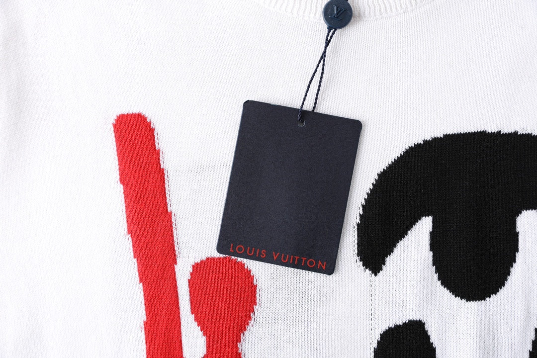 White T-shirt with red vertical line and black graphic, black hang tag near collar