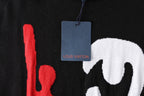 Black T-shirt close-up with hanging blue Louis Vuitton tag and red graphic
