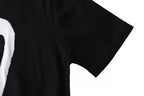 Black T-shirt short sleeve close-up, smooth fabric with side seam
