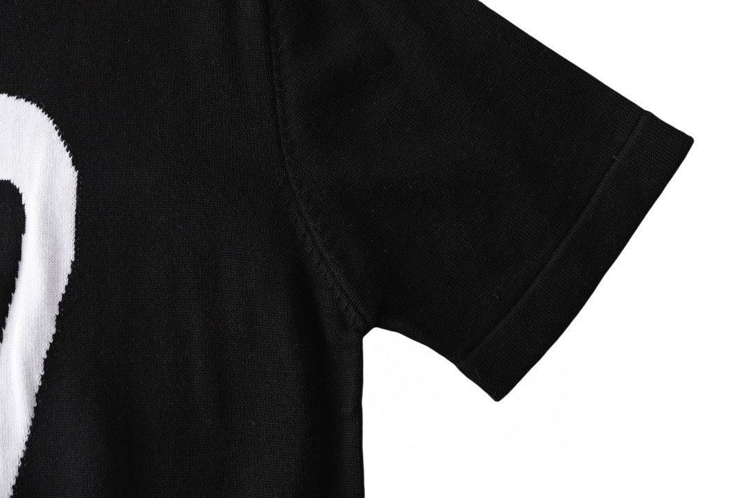 Black T-shirt short sleeve close-up, smooth fabric with side seam