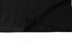 Black T-shirt hem and draped fabric close-up