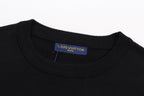 Black T-shirt neckline with blue brand label at collar