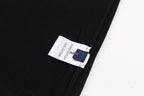 Black T-shirt with fabric tag on side hem