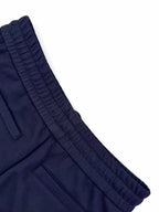 Navy waistband and side pocket seam detail on wide trousers
