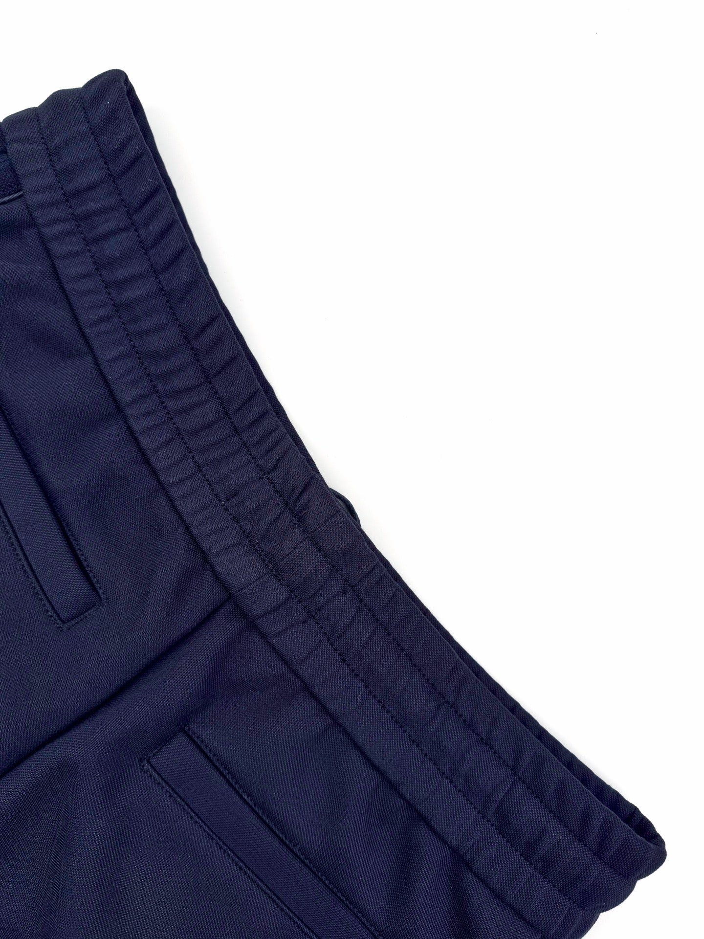 Navy waistband and side pocket seam detail on wide trousers