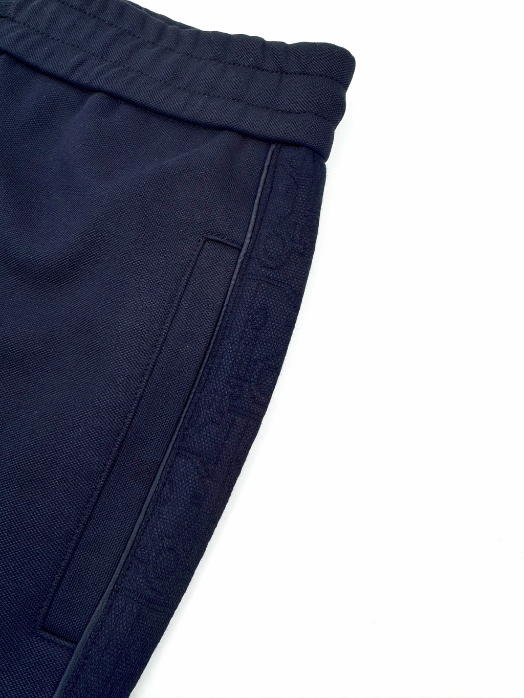 Navy pocket panel detail with topstitching and seam lines