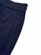 Navy pocket panel detail with topstitching and seam lines