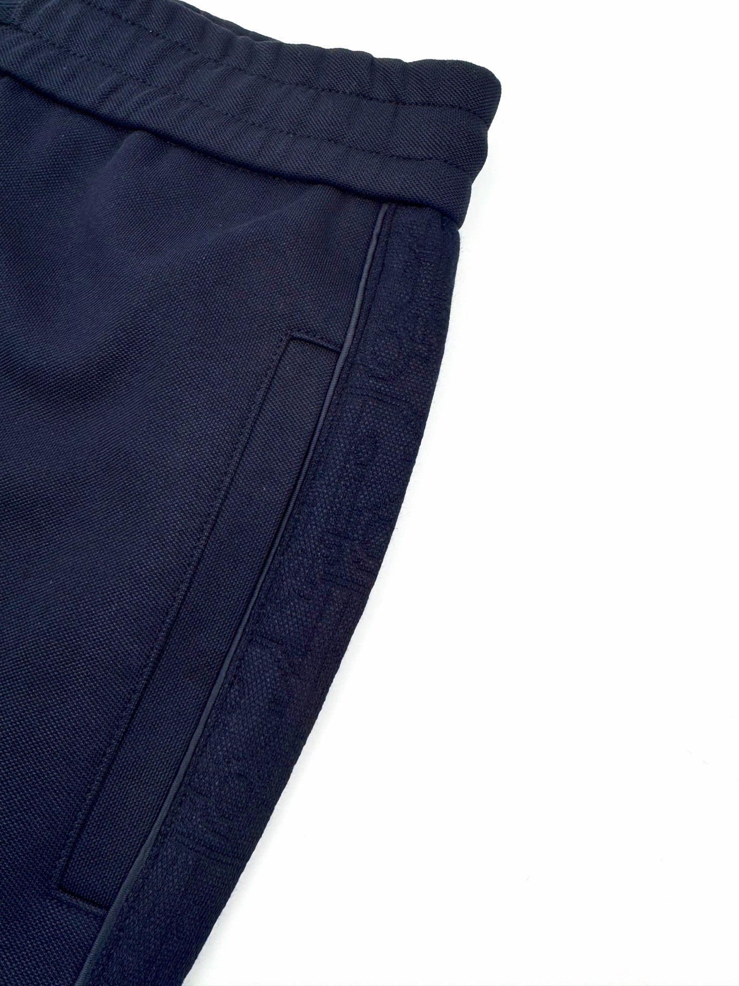 Navy pocket panel detail with topstitching and seam lines