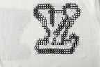 Light blue T-shirt chest graphic with black studded LV heart motif