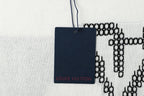 Light blue T-shirt with navy hanging Louis Vuitton tag and black LV motif