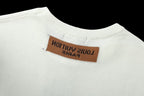 White crewneck T-shirt with brown logo label at the neckline