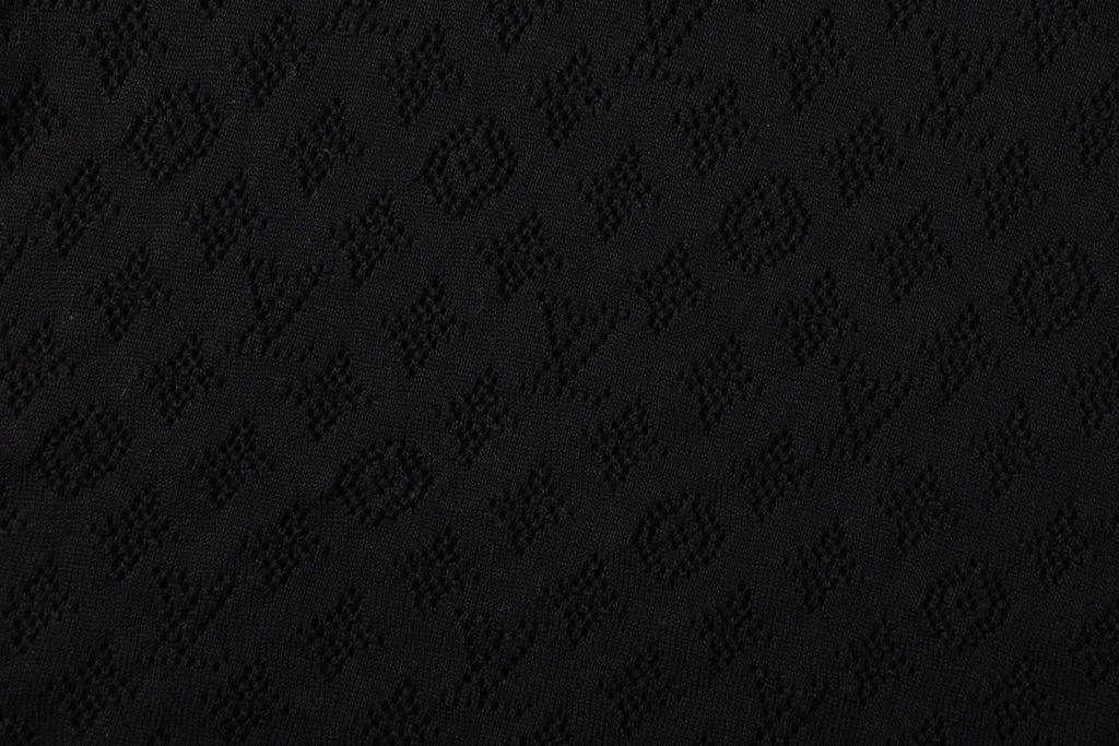 Black T-shirt fabric with subtle monogram pattern texture