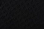 Black T-shirt fabric with subtle monogram pattern texture
