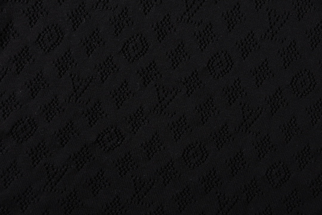 Black T-shirt fabric with subtle monogram pattern texture