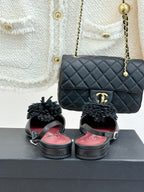 Black Chanel slingback flats with gray flower appliqués and quilted shoulder bag